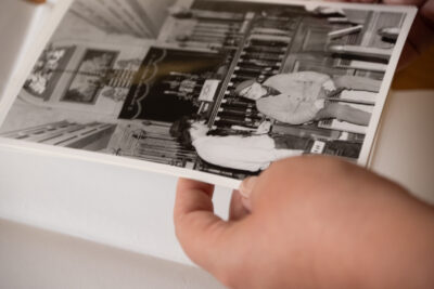 A person turning the pages of a leather bound book