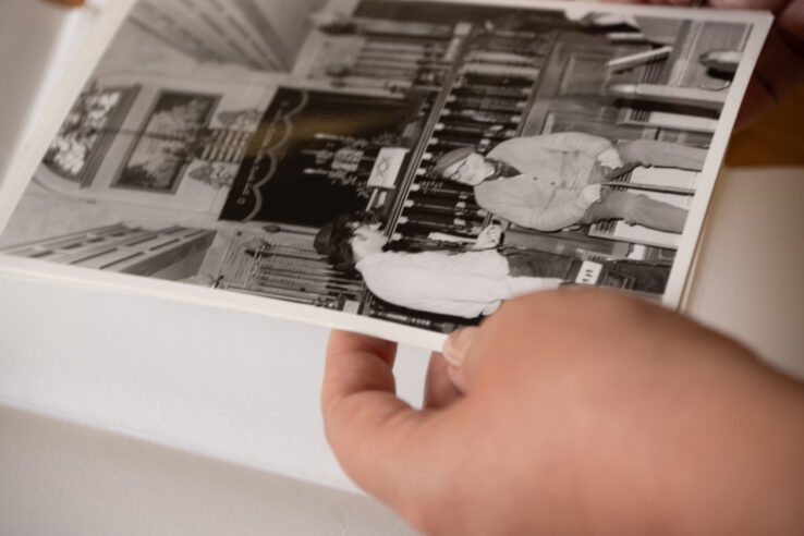 A person turning the pages of a leather bound book